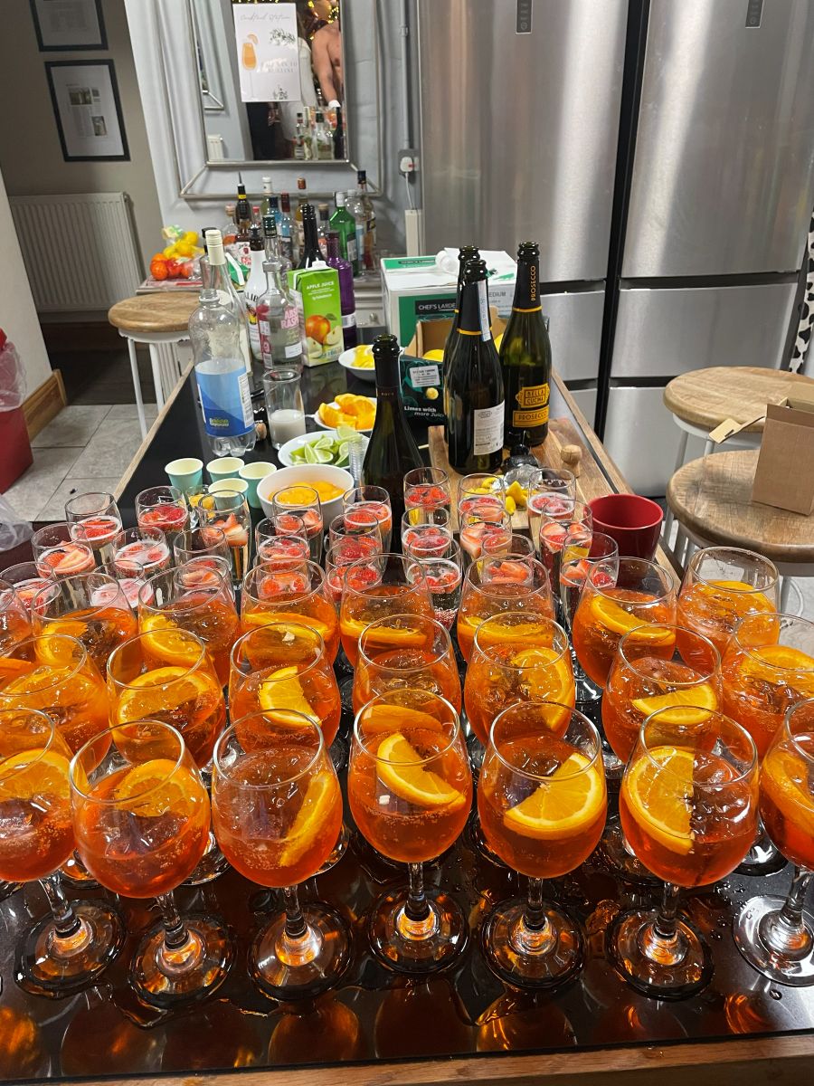A tray of Aperol spritzes garnished with orange slices