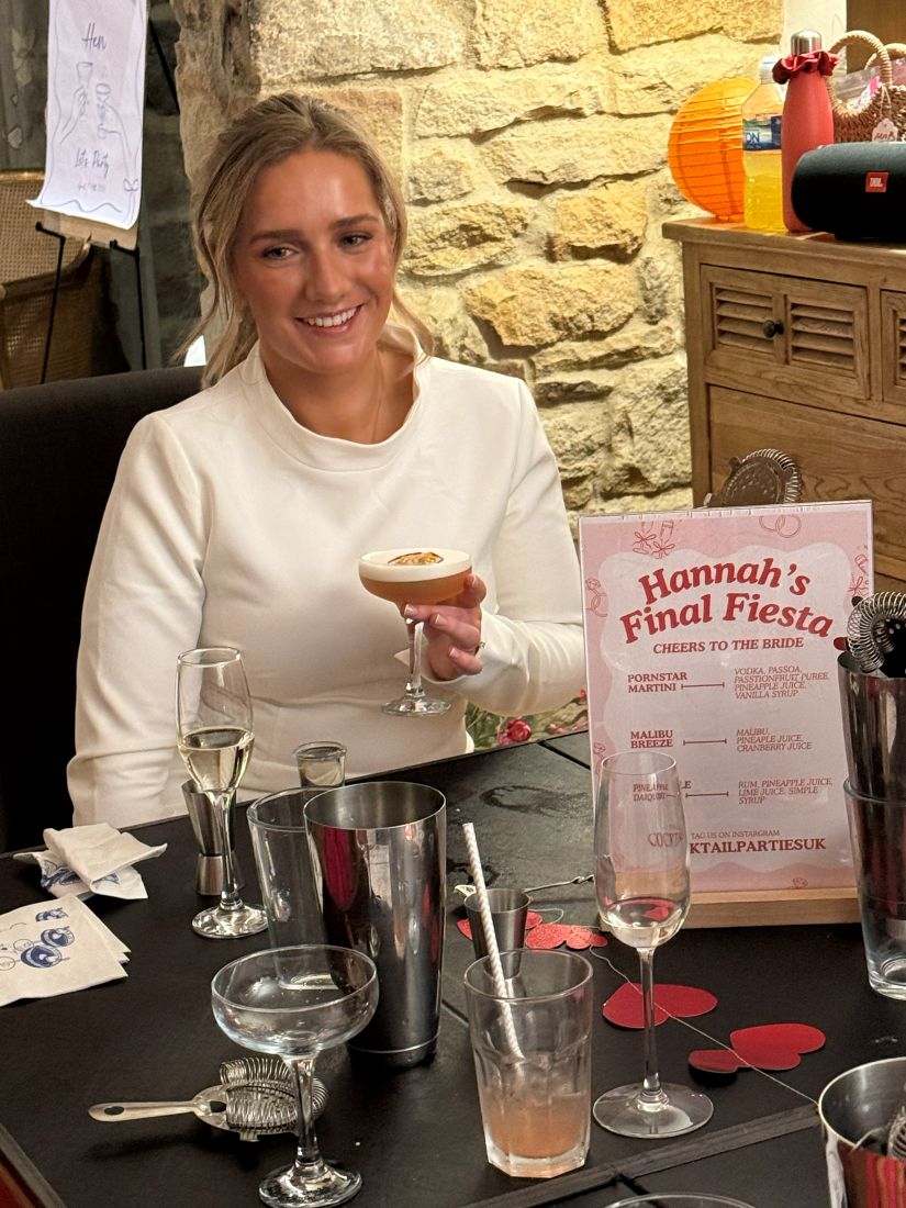 A bride-to-be holding an espresso martini beside her personalised cocktail menu