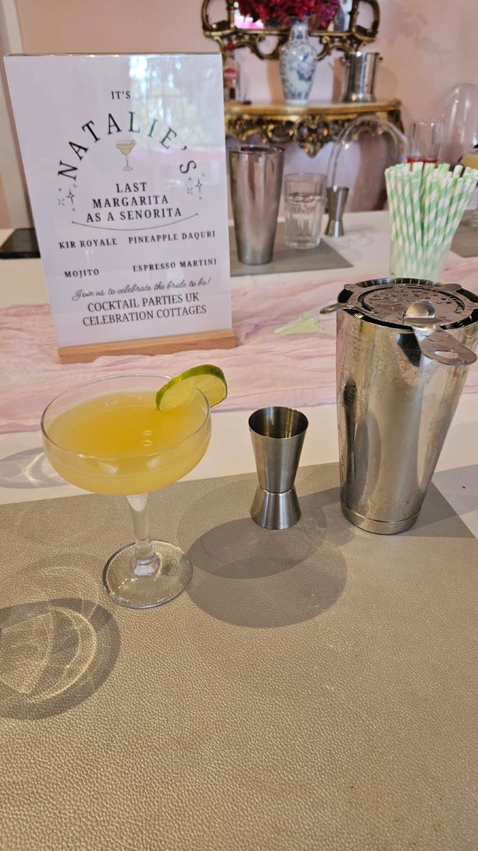 A margarita served beside a personalised cocktail menu card